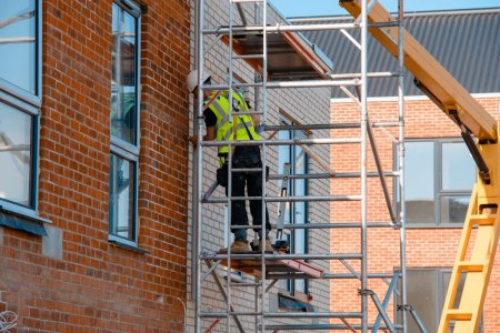 scaffold tower being used by construction worker
